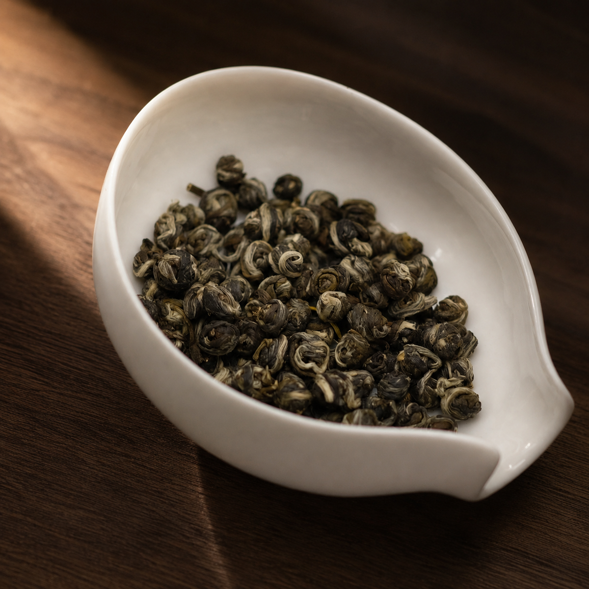 Jasmine Pearls in warm window light - Tea Chapter Singapore
